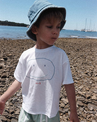 WEARING A FLAT SMILE SUPIMA® T-SHIRT